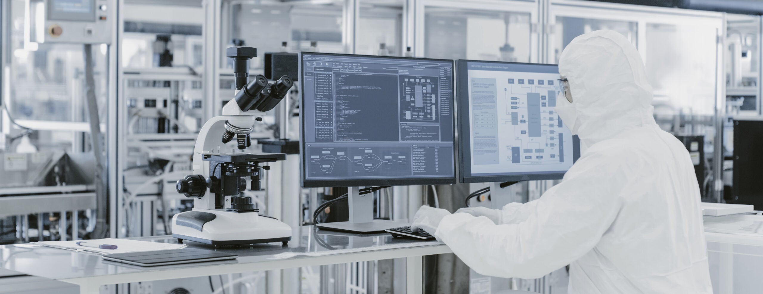 Quality-control technician working with laboratory equipment and computer monitors
